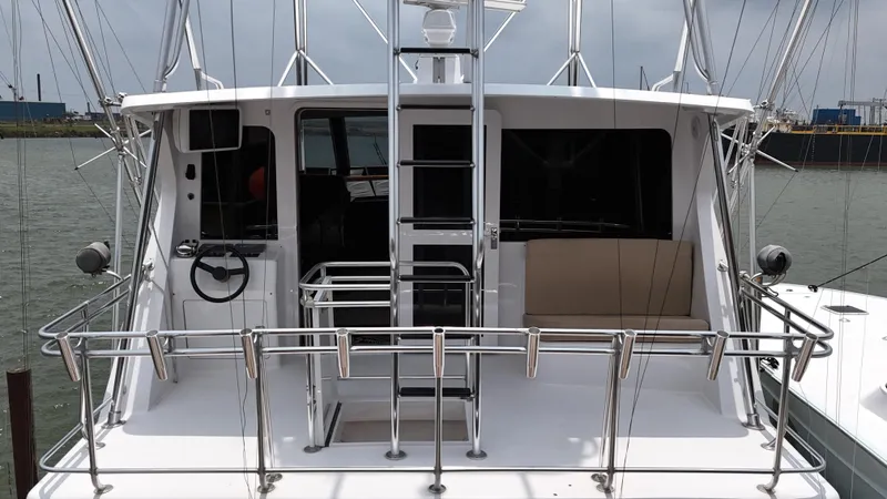 Slide: The Image of 1996 Donzi Custom Enclosed Flybridge yacht with stainless steel railings and ladder. - 6