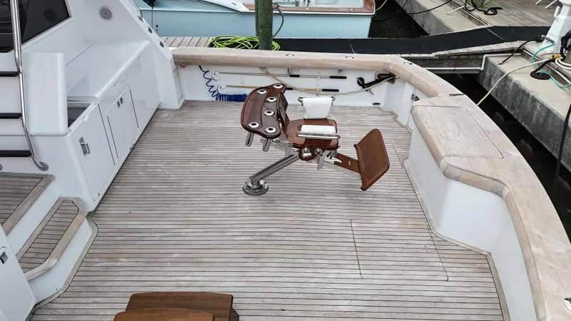 Slide: The Image of 1996 Donzi Custom Enclosed Flybridge boat deck with fishing chair. - 9