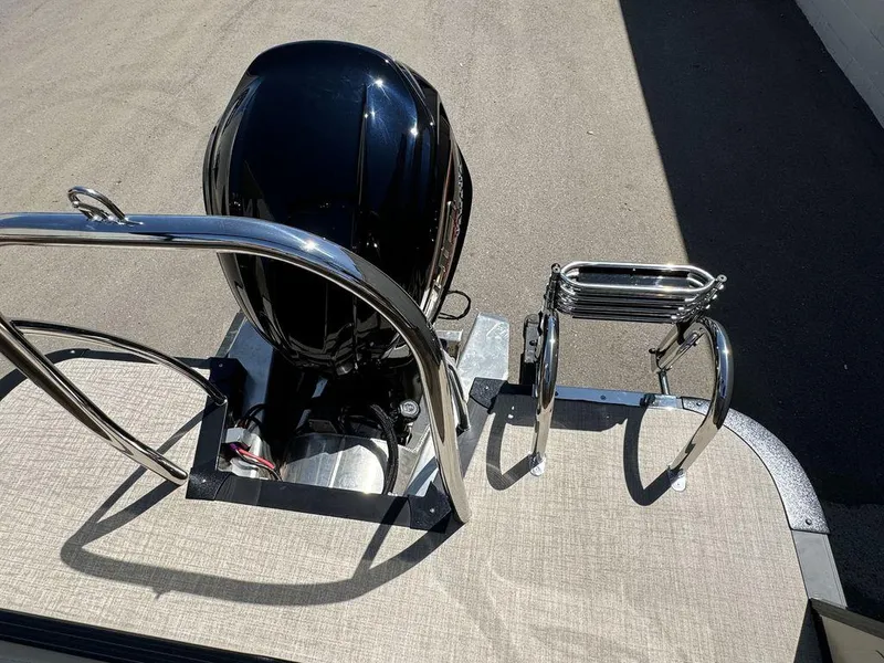 Slide: The Image of 2024 Tahoe Cascade 2385 EL boat rear view with motor and ladder. - 11