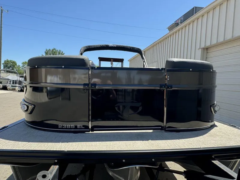 Slide: The Image of 2024 Tahoe Cascade 2385 EL pontoon boat, rear view, black exterior. - 15