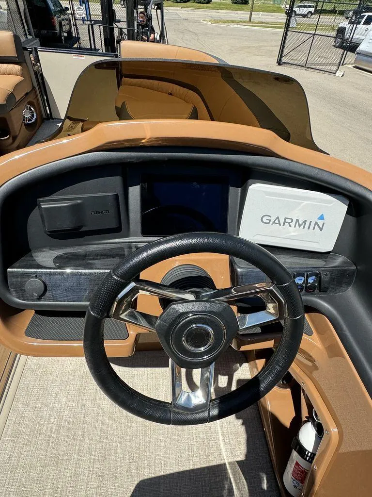 Slide: The Image of 2024 Tahoe Cascade 2385 EL boat dashboard with Garmin navigation system. - 17