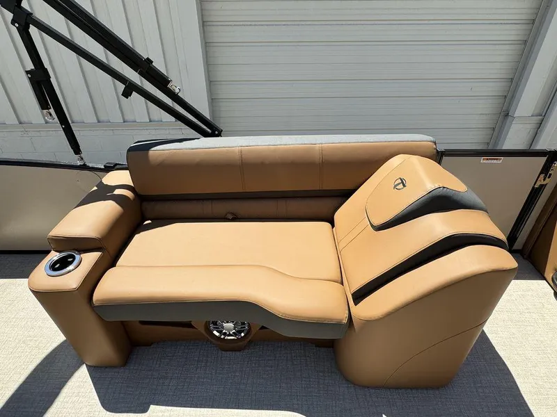 Slide: The Image of 2024 Tahoe Cascade 2385 EL boat interior with tan leather seating and cup holder. - 18