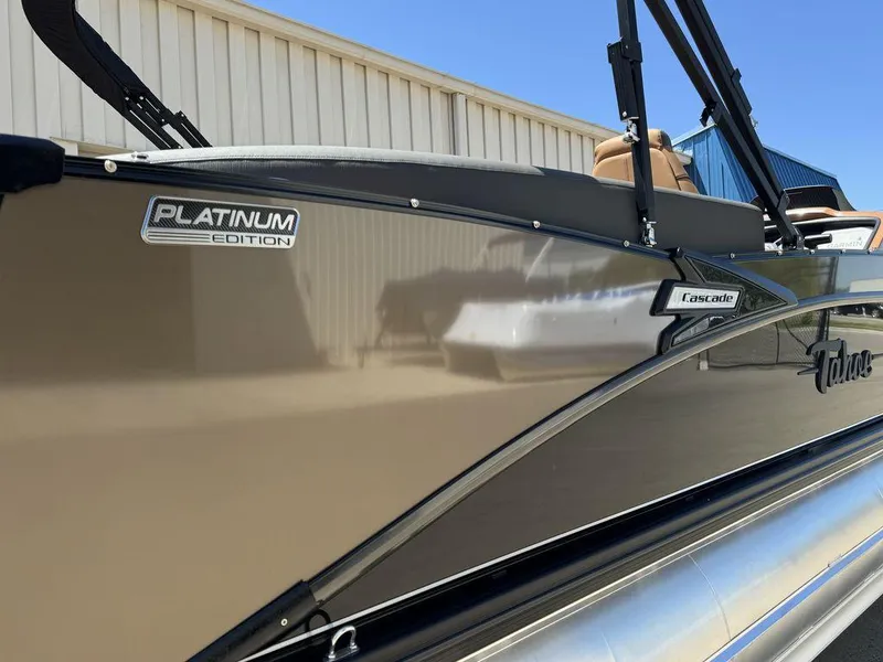 Slide: The Image of 2024 Tahoe Cascade 2385 EL Platinum Edition pontoon boat side view. - 2