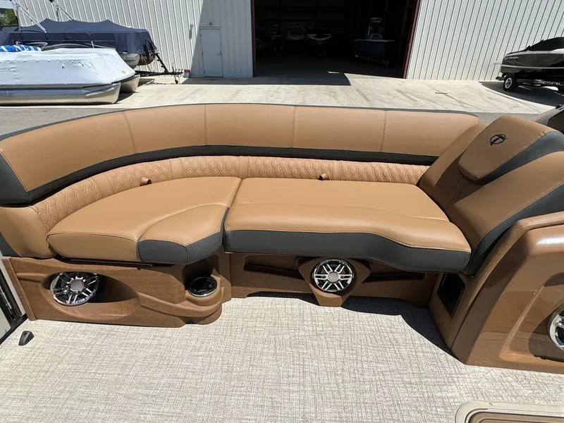Slide: The Image of 2024 Tahoe Cascade 2385 EL boat interior with tan and black seating. - 4