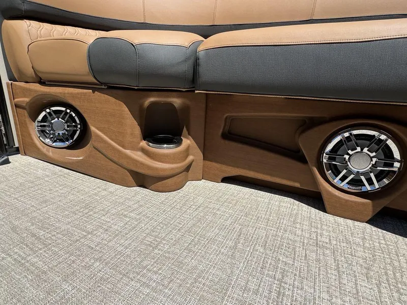 Slide: The Image of 2024 Tahoe Cascade 2385 EL boat interior with speakers and cup holder. - 5
