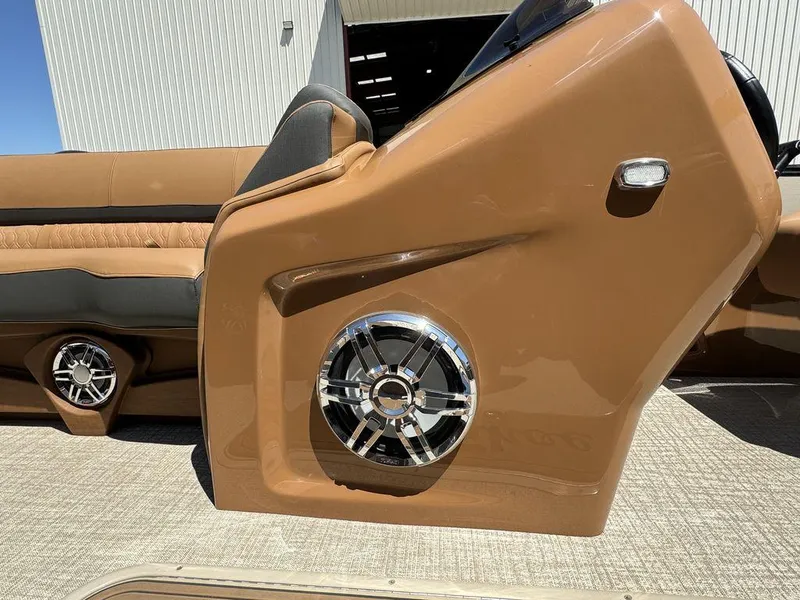 Slide: The Image of 2024 Tahoe Cascade 2385 EL boat interior with premium sound system and tan upholstery. - 7