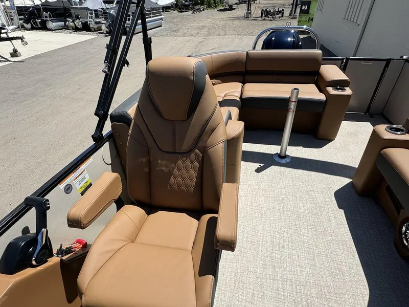 Slide: The Image of 2024 Tahoe Cascade 2385 EL boat interior with tan leather seating and modern design. - 8