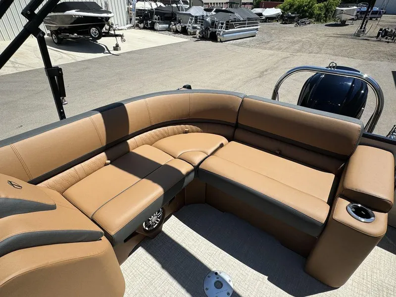 Slide: The Image of 2024 Tahoe Cascade 2385 EL boat with tan and black seating. - 9