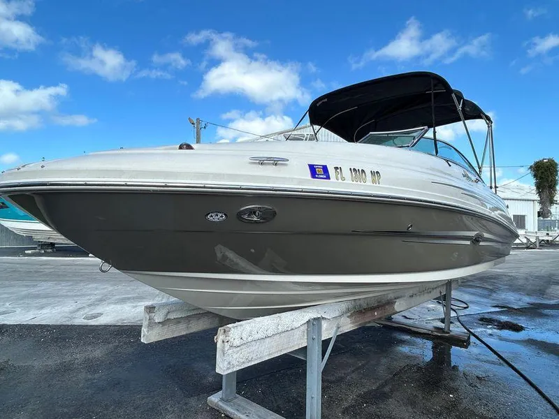 Slide: The Image of 2007 Sea Ray 220 Sundeck boat on a lift, clear sky background. - 11