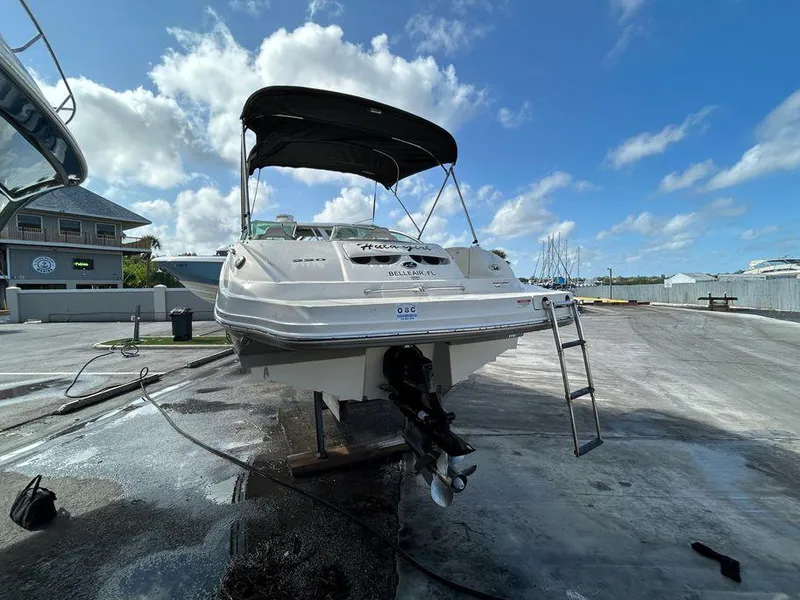 Slide: The Image of 2007 Sea Ray 220 Sundeck boat on a dock under a blue sky. - 13