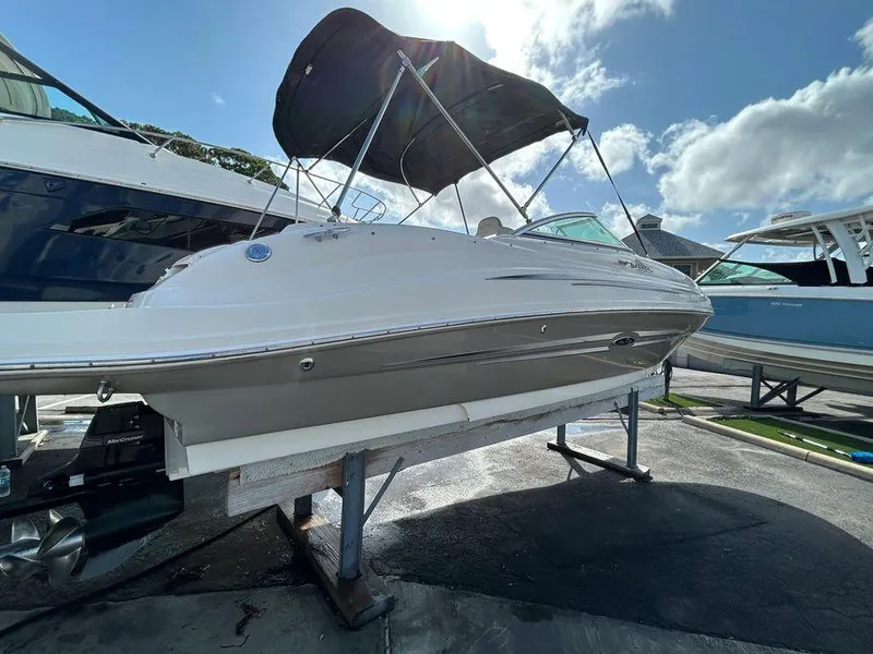 Slide: The Image of 2007 Sea Ray 220 Sundeck boat on a stand under a sunny sky. - 15