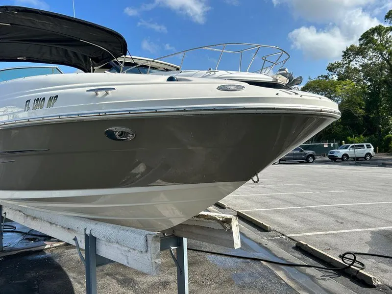 Slide: The Image of 2007 Sea Ray 220 Sundeck boat on a trailer in a parking lot. - 18