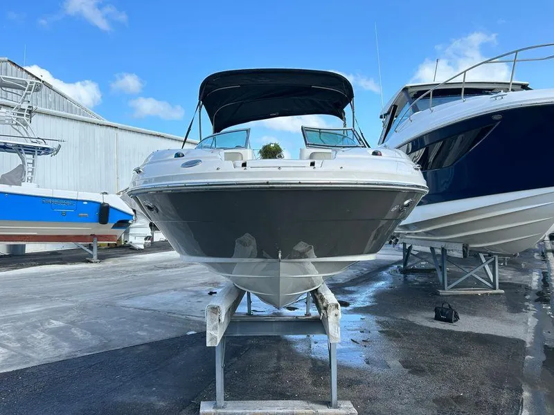 Slide: The Image of 2007 Sea Ray 220 Sundeck boat on a stand in a marina. - 2