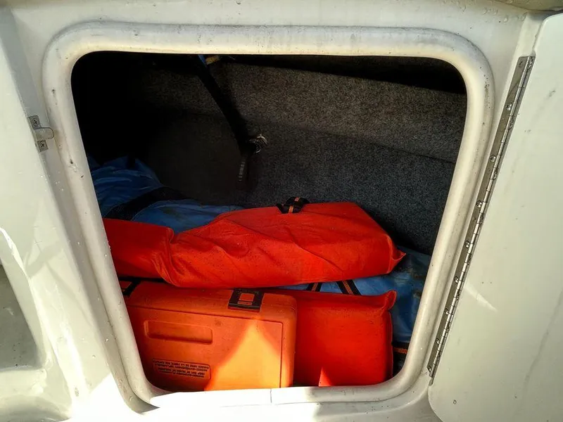 Slide: The Image of Storage compartment of a 2007 Sea Ray 220 Sundeck with life jackets and equipment. - 24