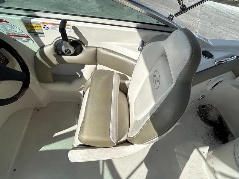 Slide: The Image of 2007 Sea Ray 220 Sundeck captain's chair and control console. - 26