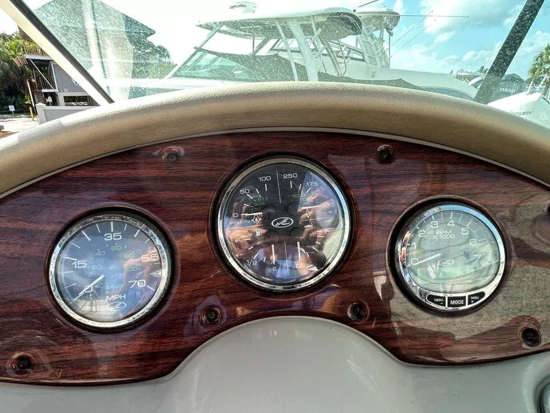 Slide: The Image of Dashboard of a 2007 Sea Ray 220 Sundeck boat with speedometer and gauges. - 27