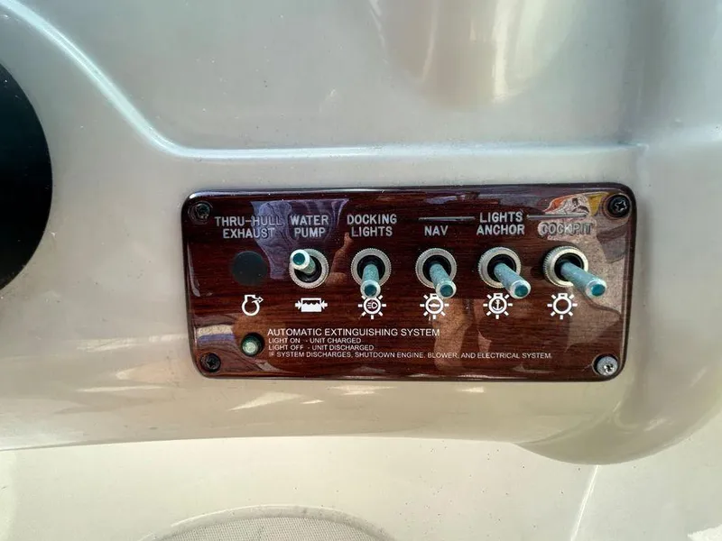 Slide: The Image of Control panel of a 2007 Sea Ray 220 Sundeck boat with various switches. - 29