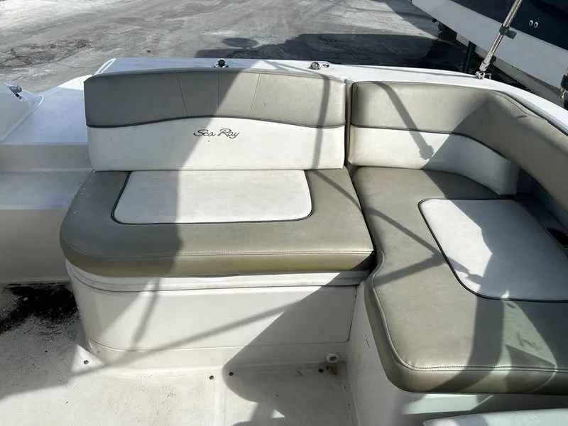 Slide: The Image of 2007 Sea Ray 220 Sundeck boat seating area with gray and white upholstery. - 31