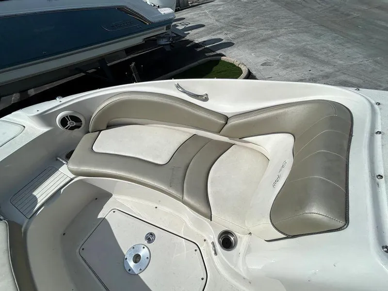 Slide: The Image of 2007 Sea Ray 220 Sundeck bow seating area with white and beige upholstery. - 34