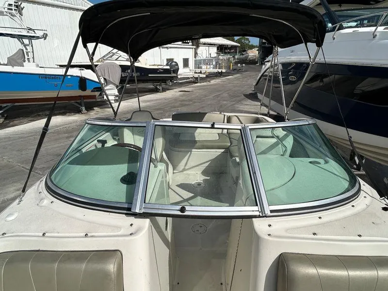 Slide: The Image of 2007 Sea Ray 220 Sundeck boat with black canopy and spacious seating. - 37