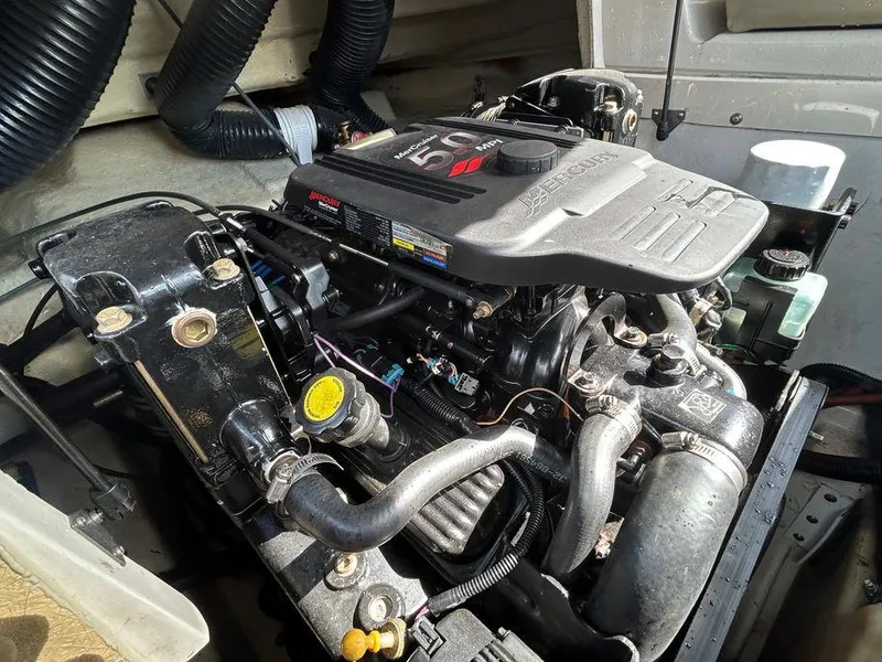 Slide: The Image of 2007 Sea Ray 220 Sundeck engine compartment with a 5.0L MerCruiser engine. - 38