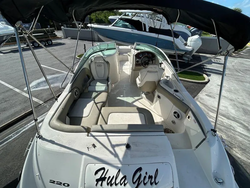 Slide: The Image of 2007 Sea Ray 220 Sundeck boat with Hula Girl name, spacious seating, and canopy. - 4