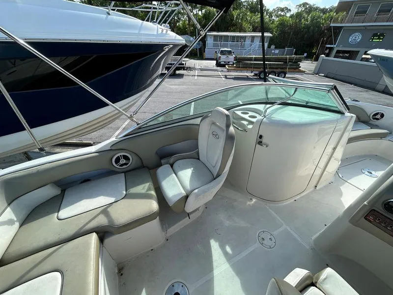 Slide: The Image of 2007 Sea Ray 220 Sundeck boat interior with seating and control console. - 6