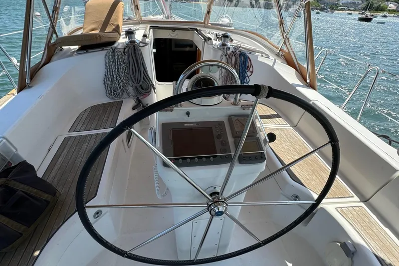 Slide: The Image of Cockpit of 2005 Beneteau 423 sailboat with steering wheel and navigation equipment. - 15