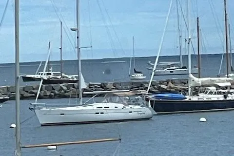 Slide: The Image of Sailboats docked in a marina, featuring a 2005 Beneteau 423. - 2
