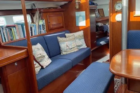 Slide: The Image of Interior of 2005 Beneteau 423 yacht with blue seating and wooden furnishings. - 22