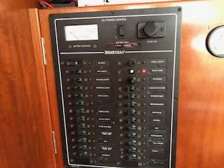 Slide: The Image of Electrical panel of a 2005 Beneteau 423 yacht, featuring various switches and controls. - 31