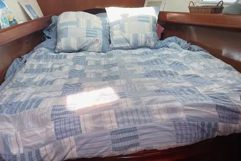 Slide: The Image of Cozy cabin bed with blue checkered bedding on a 2005 Beneteau 423 yacht. - 34