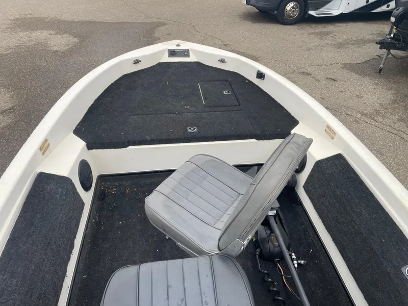 Slide: The Image of 1990 Skeeter S-50 boat interior with gray seats and black carpet. - 11