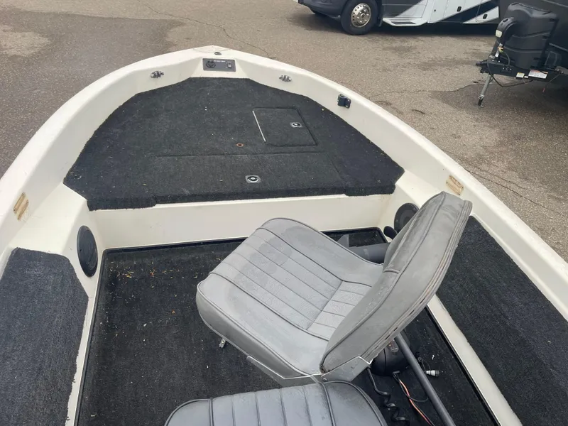 Slide: The Image of 1990 Skeeter S-50 boat interior with gray seating and black carpet. - 6