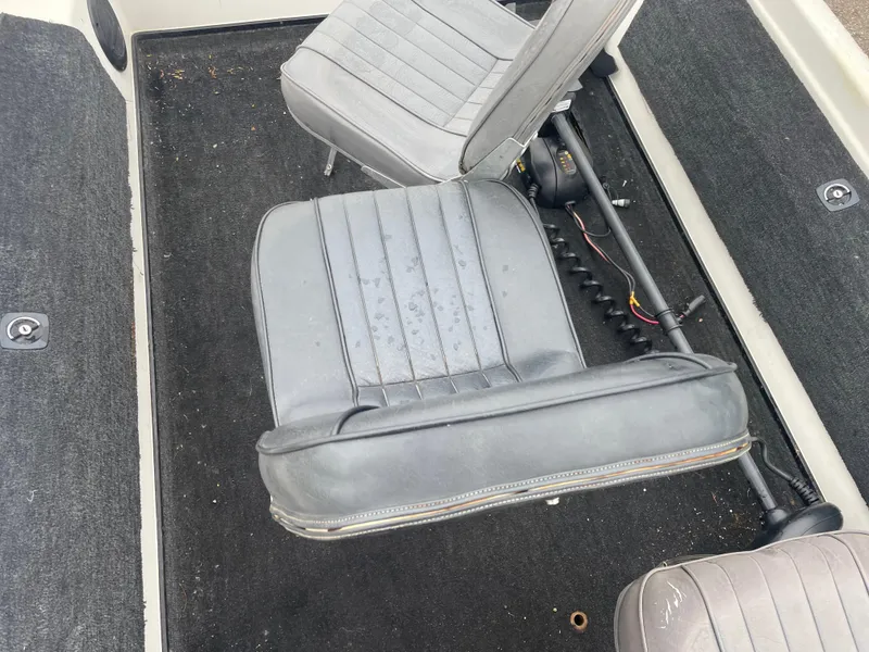 Slide: The Image of 1990 Skeeter S-50 boat interior with gray seats and black carpet. - 7