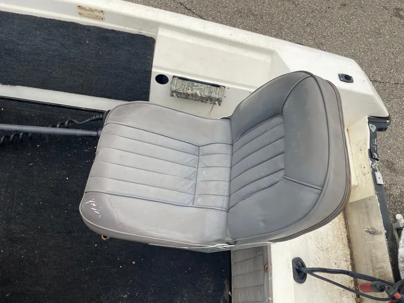 Slide: The Image of Gray seat on a 1990 Skeeter S-50 boat, showing wear and tear. - 8