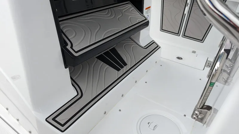 Slide: The Image of 2024 Wellcraft 263 Fisherman boat interior with non-slip flooring and storage compartments. - 10