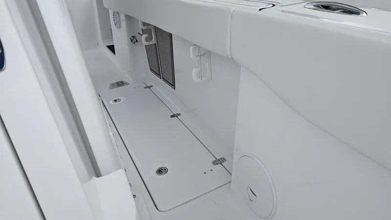 Slide: The Image of 2024 Wellcraft 263 Fisherman boat interior deck with storage compartments. - 13