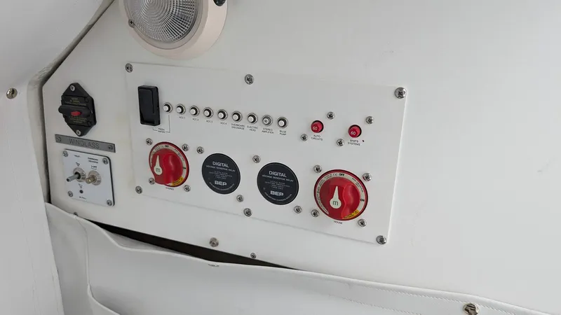 Slide: The Image of Control panel of a 2024 Wellcraft 263 Fisherman boat with switches and dials. - 15