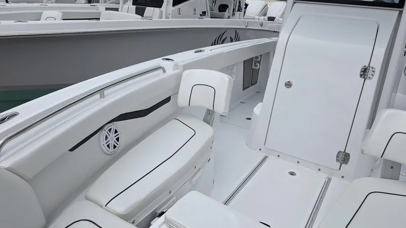Slide: The Image of 2024 Wellcraft 263 Fisherman boat interior with white seating and storage compartments. - 18