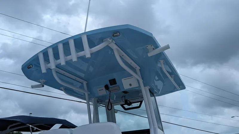 Slide: The Image of 2024 Wellcraft 263 Fisherman boat with blue T-top under cloudy sky. - 20