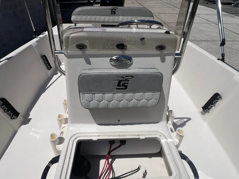 Slide: The Image of 2024 Carolina Skiff EV198 boat interior with open storage compartment and seating. - 10