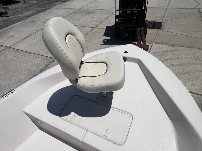 Slide: The Image of 2024 Carolina Skiff EV198 boat with a cushioned swivel seat on deck. - 11