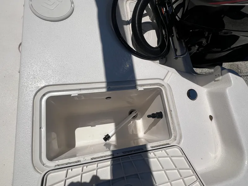 Slide: The Image of 2024 Carolina Skiff EV198 boat storage compartment and engine area. - 14