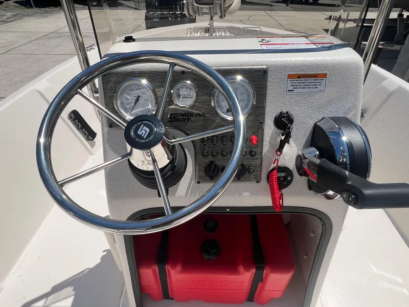 Slide: The Image of 2024 Carolina Skiff EV198 boat console with steering wheel and control panel. - 15