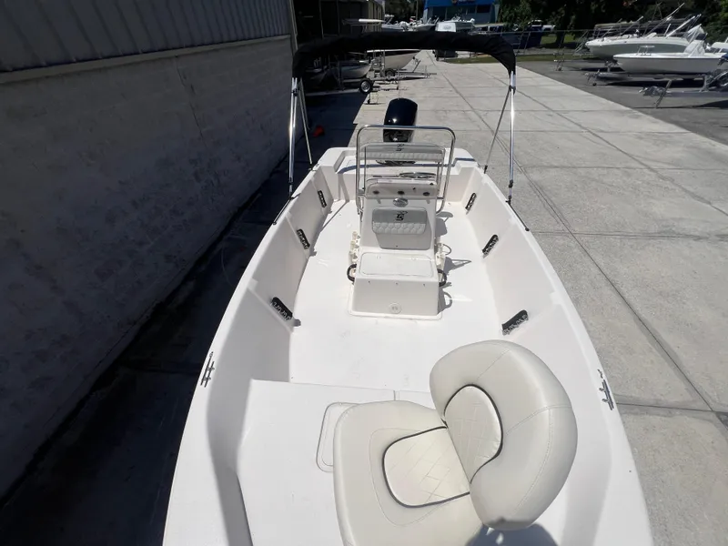 Slide: The Image of 2024 Carolina Skiff EV198 boat with white interior and center console. - 6