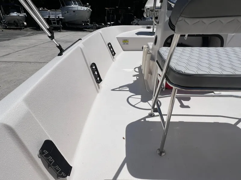 Slide: The Image of 2024 Carolina Skiff EV198 boat interior with seating and storage compartments. - 8