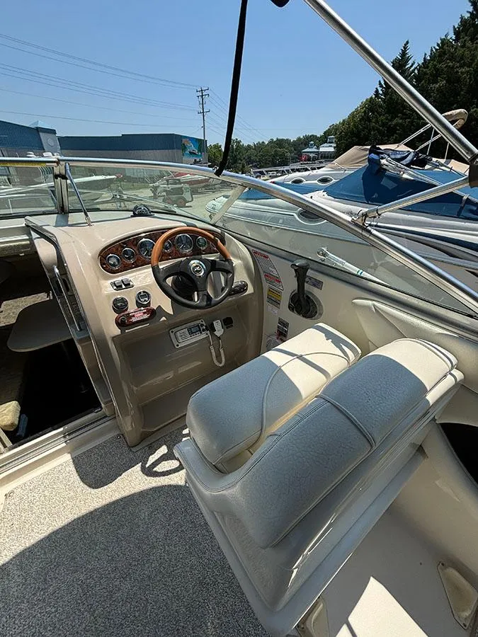 Slide: The Image of 2003 Sea Ray 225 Weekender boat interior with helm and seating - 13