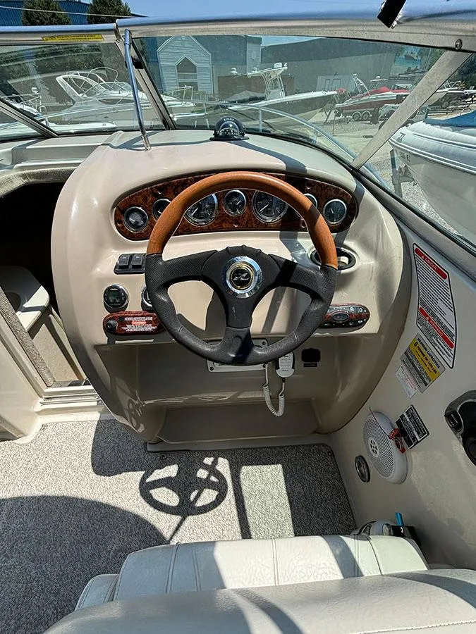 Slide: The Image of 2003 Sea Ray 225 Weekender boat helm with steering wheel and instrument panel. - 15