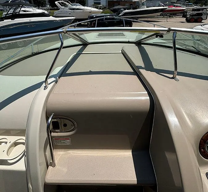 Slide: The Image of 2003 Sea Ray 225 Weekender boat deck with windshield and handrails. - 16